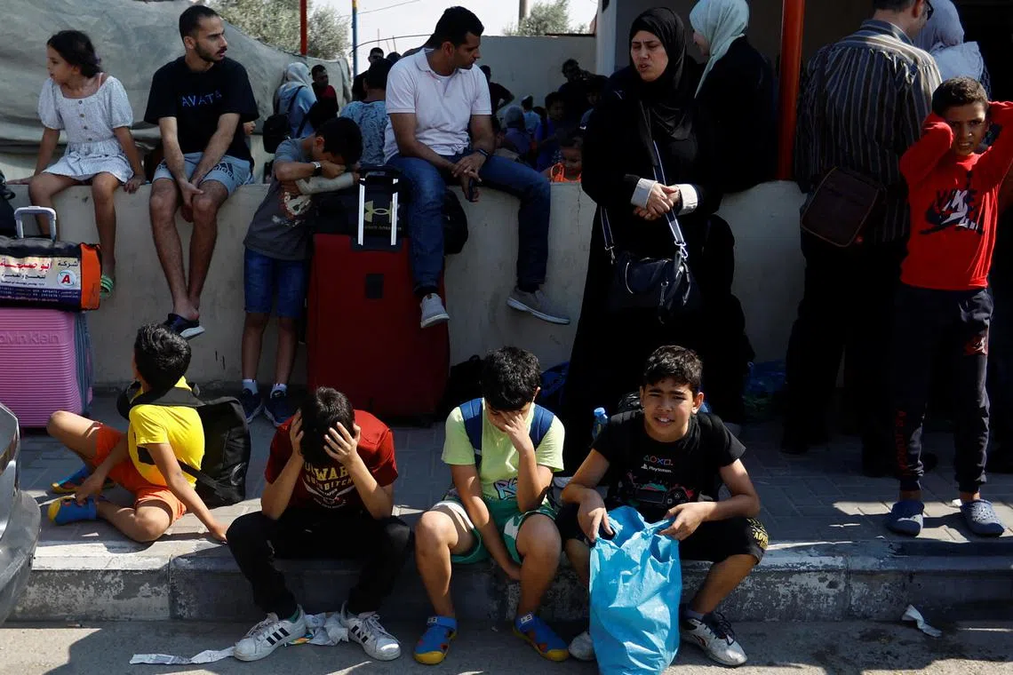 Palestinians with dual citizenship wait outside the Rafah border crossing with Egypt, in the hope of getting permission to leave Gaza.