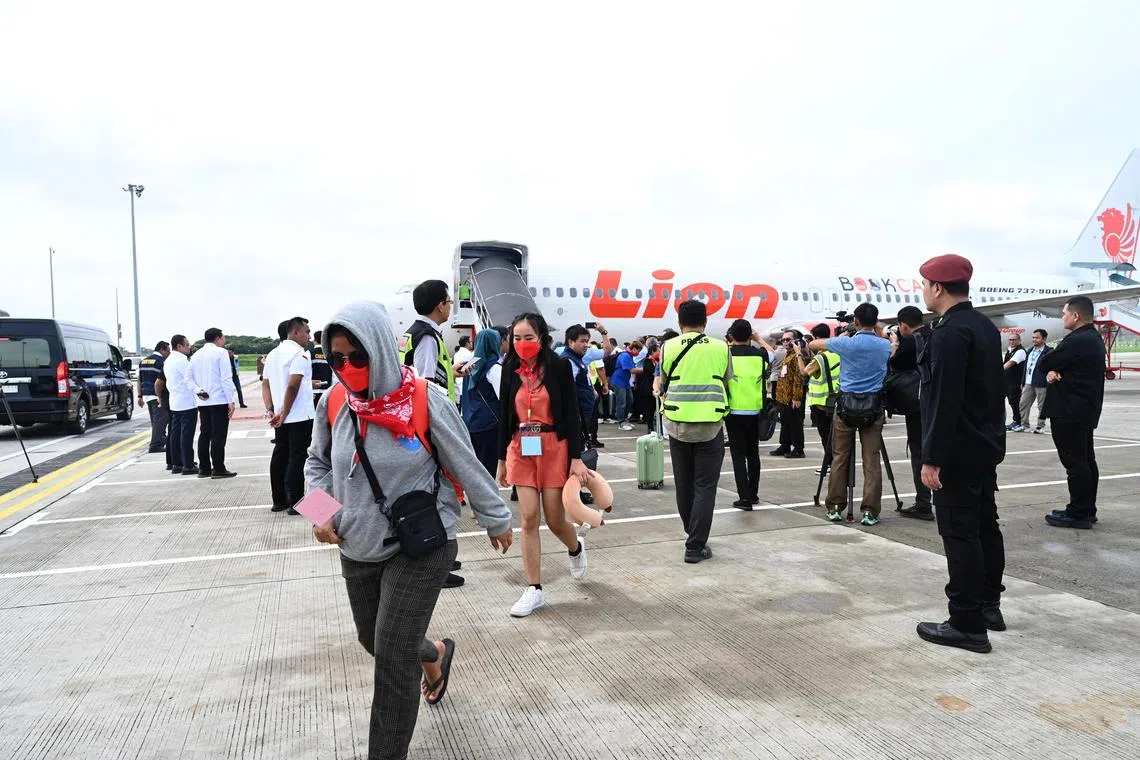 Indonesian workers arrive at Jakarta airport from Myanmar online scam compounds on March 18. The police said many scammers have moved to South-east Asia after a Chinese crackdown on networks.