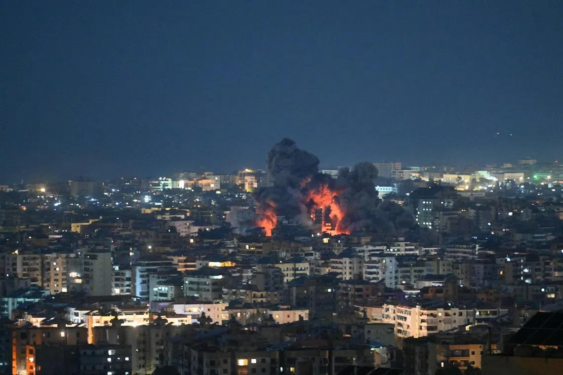 Fire blazes and black smoke rises from the site of an Israeli airstrike that targeted the office of the Hezbollah affiliated Al-Manar TV station in Beirut’s southern suburb of Haret Hreik on March 3.