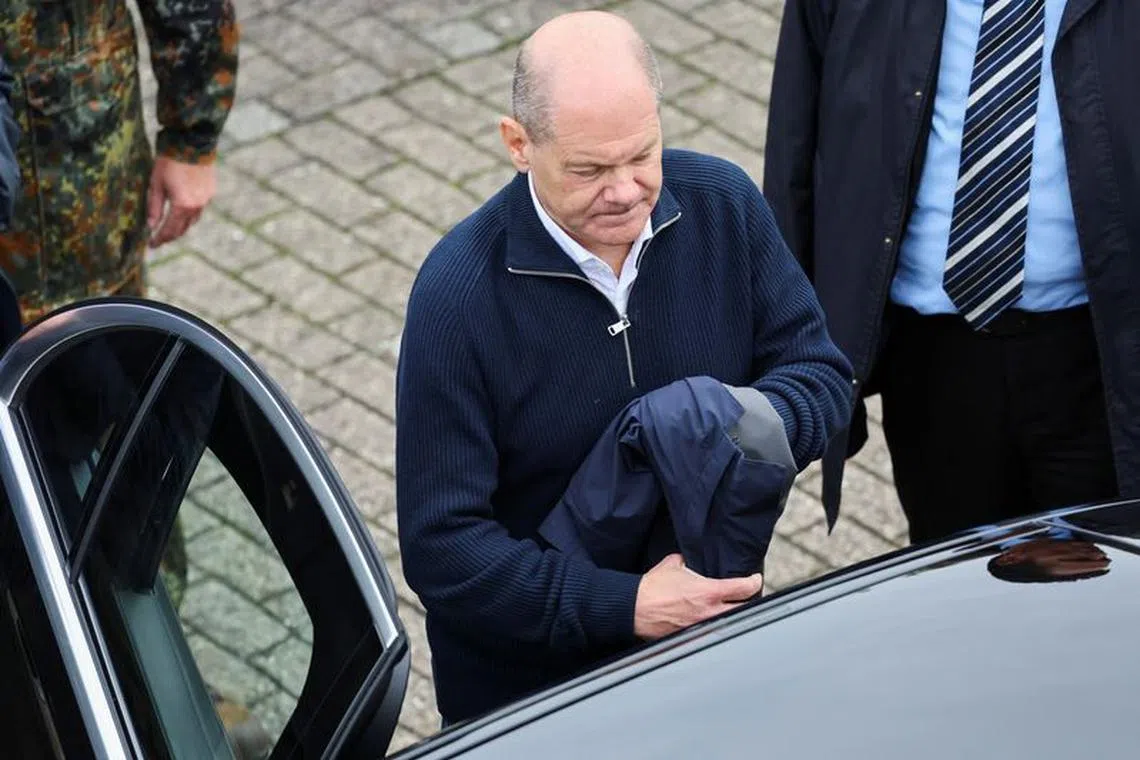 German Chancellor Olaf Scholz prepares to enter a car after his visit to the Cologne-Bonn Air Force base to attend a demonstration of the capabilities of the Territorial Command of the German army Bundeswehr in Wahn, a suburb of Cologne, Germany, October 23, 2023.  REUTERS/Wolfgang Rattay