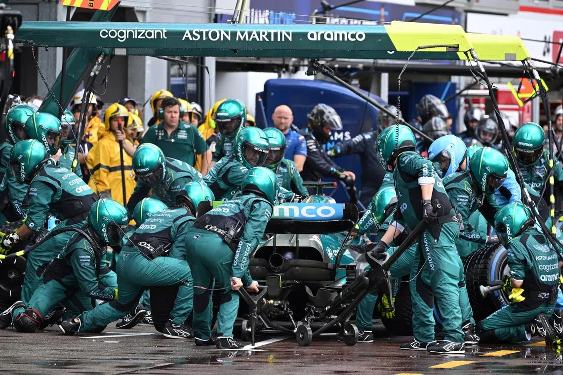 FILE PHOTO: Formula One F1 - Monaco Grand Prix - Circuit de Monaco, Monte Carlo, Monaco - May 29, 2022 Aston Martin team members in action as Lance Stroll makes a pit stop during the race Pool via REUTERS/Christian Bruna/File Photo
