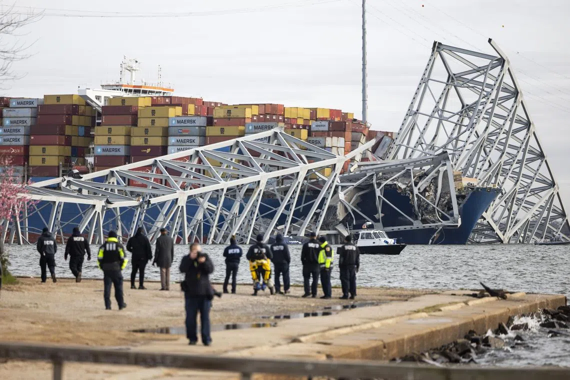 Rescue personnel gathering on the shore of the Patapsco River after a container ship ran into the Francis Scott Key Bridge causing its collapse in Baltimore, Maryland, US, on March 26, 2024. 