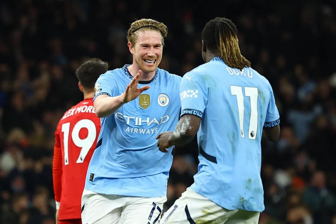 Manchester City's Kevin De Bruyne celebrates scoring their second goal with teammate Jeremy Doku.
