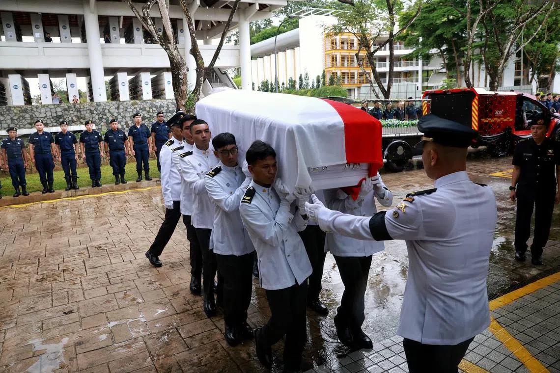Pallbearers carrying the casket of Sergeant (1) Edward H Go into Service Hall 1.