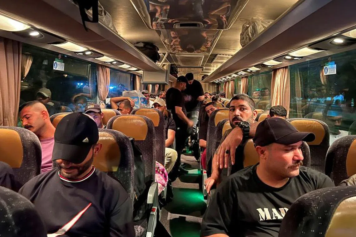 Supporters of Iraq's Popular Mobilisation Forces (PMF), ride in a bus heading to Iraq's main border crossing with Jordan to express solidarity with Gaza, in Baghdad, Iraq, October 20, 2023. REUTERS/Haider Kadhim/File Photo