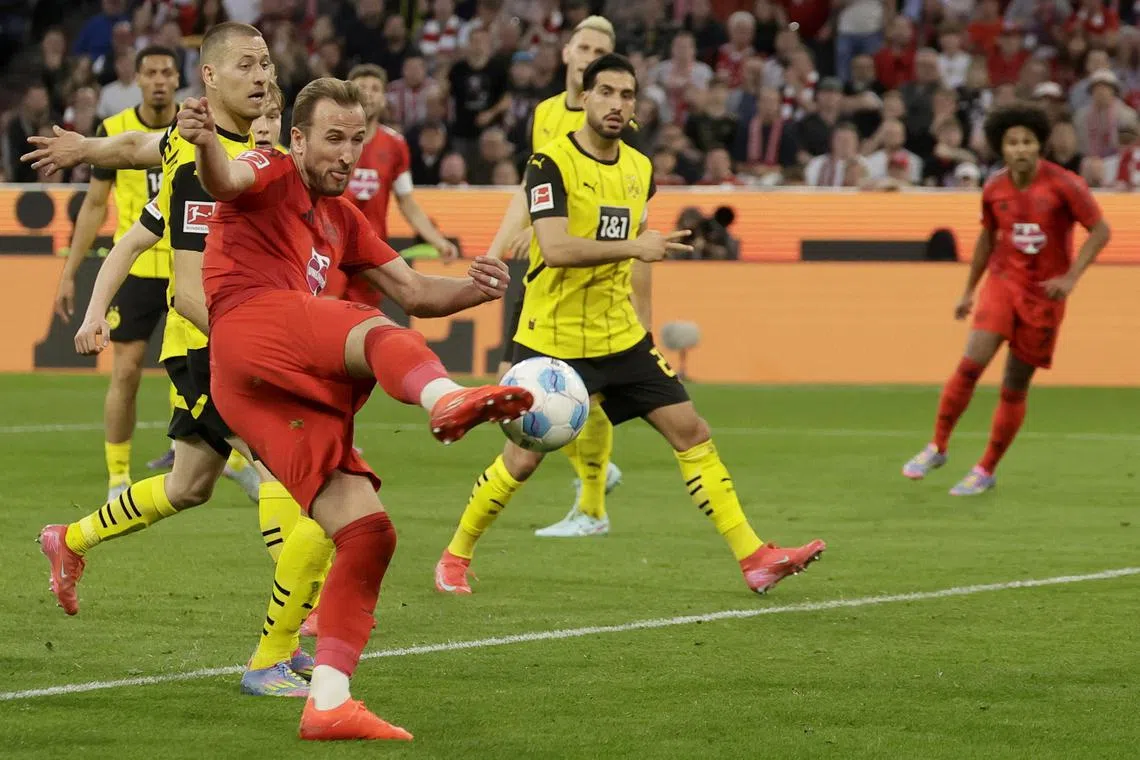 Bayern Munich striker Harry Kane taking a shot during the 2-2 Bundesliga draw against Borussia Dortmund at the Allianz Arena on April 12.