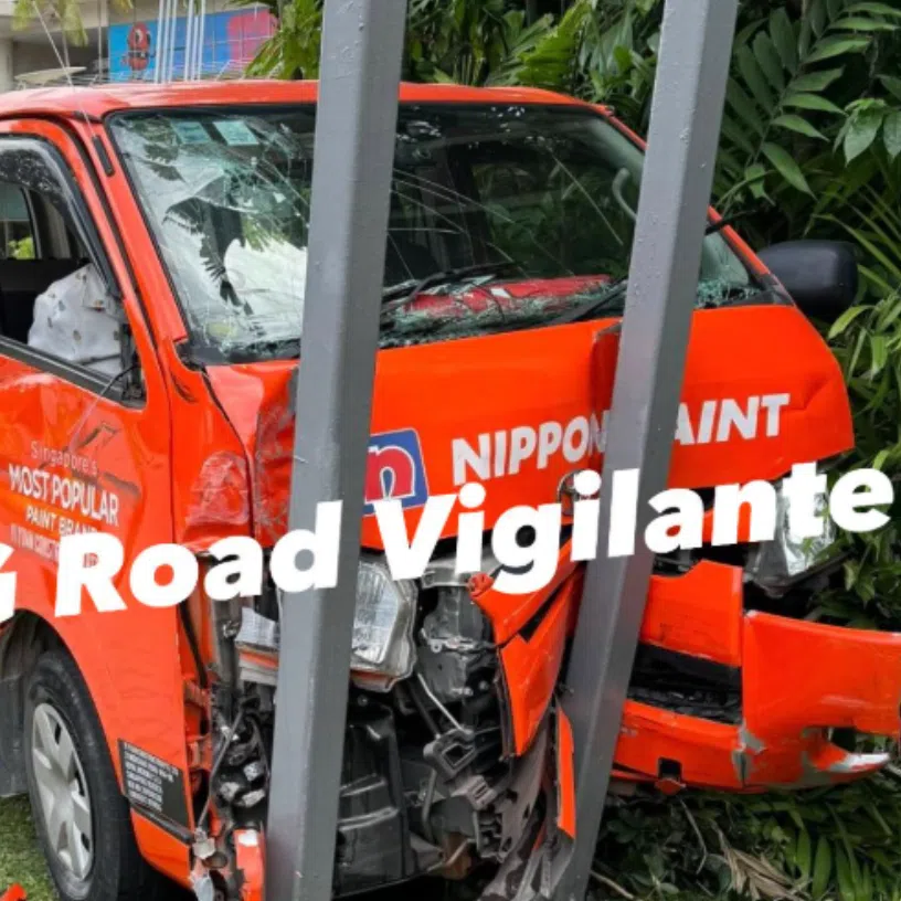 A van bearing the livery of Nippon Paint is seen crashed into a traffic signpost in Raffles Avenue.