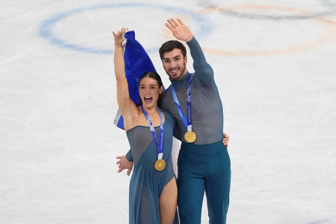 Feb 11, 2026; Milan, Italy; Laurence Fournier Beaudry and Guillaume Cizeron of France skate after receiving their medals during the Milano Cortina 2026 Olympic Winter Games at Milano Ice Skating Arena. Mandatory Credit: Amber Searls-Imagn Images