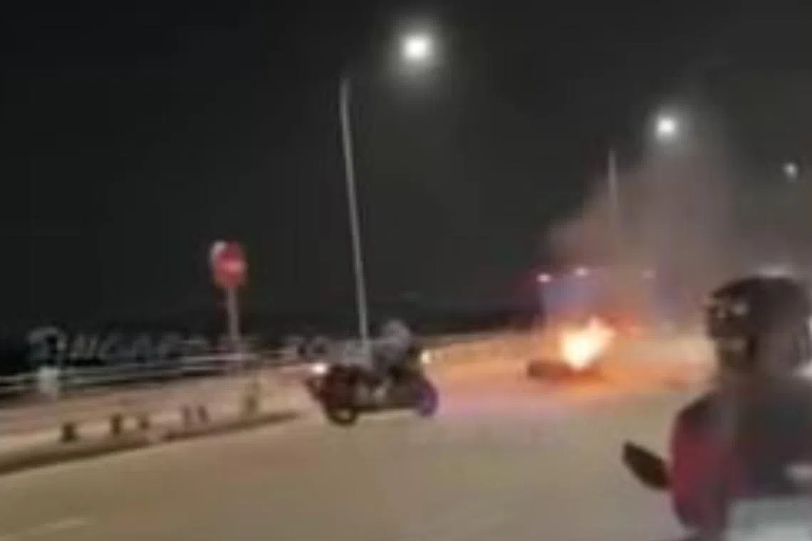 The Singaporean's motorbike collided with a car that was making a U-turn, and the bike subsequently caught fire.