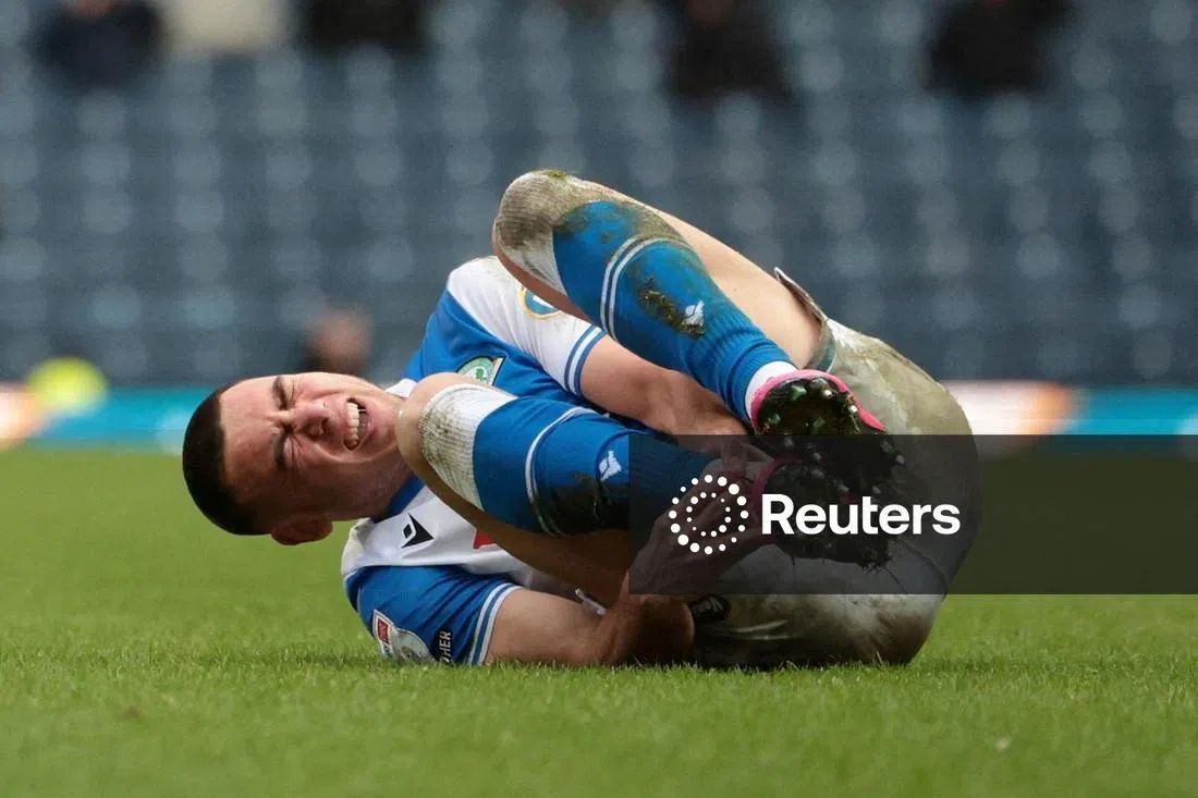 FILE PHOTO: Soccer Football - Championship - Blackburn Rovers v Millwall - Ewood Park, Blackburn, Britain - December 20, 2025  Blackburn Rovers' Lewis Miller reacts on the ground holding his ankle Action Images/John Clifton /File Photo