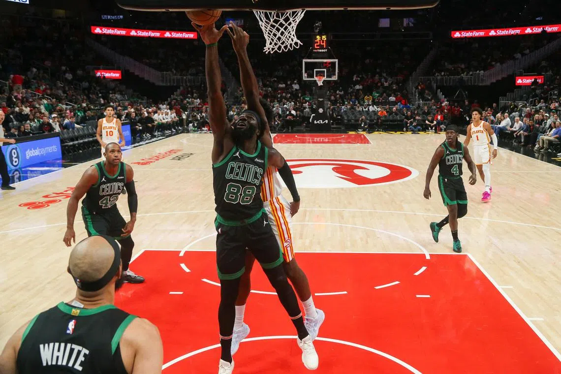 Boston Celtics centre Neemias Queta grabs a rebound against the Atlanta Hawks in the first half at State Farm Arena.