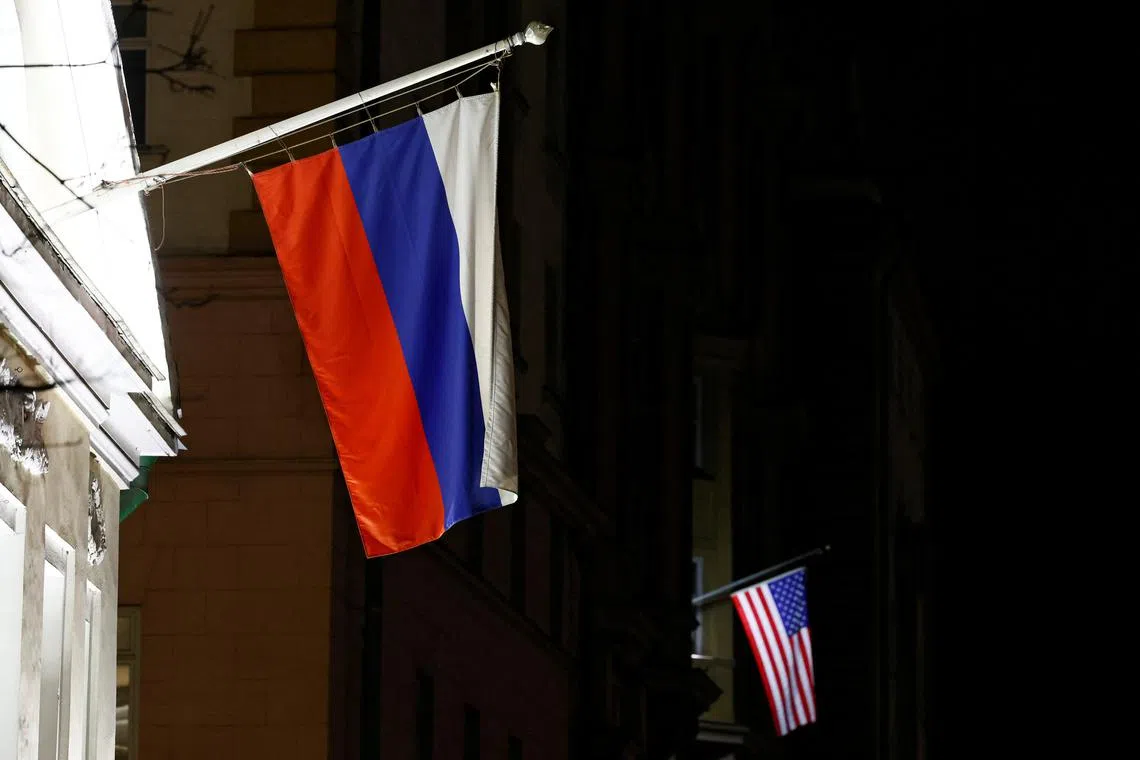 A view shows the Russian flag on the facade of a historic building alongside the American flag on the facade of the U.S. Embassy in Moscow, Russia March 18, 2025. REUTERS/Yulia Morozova