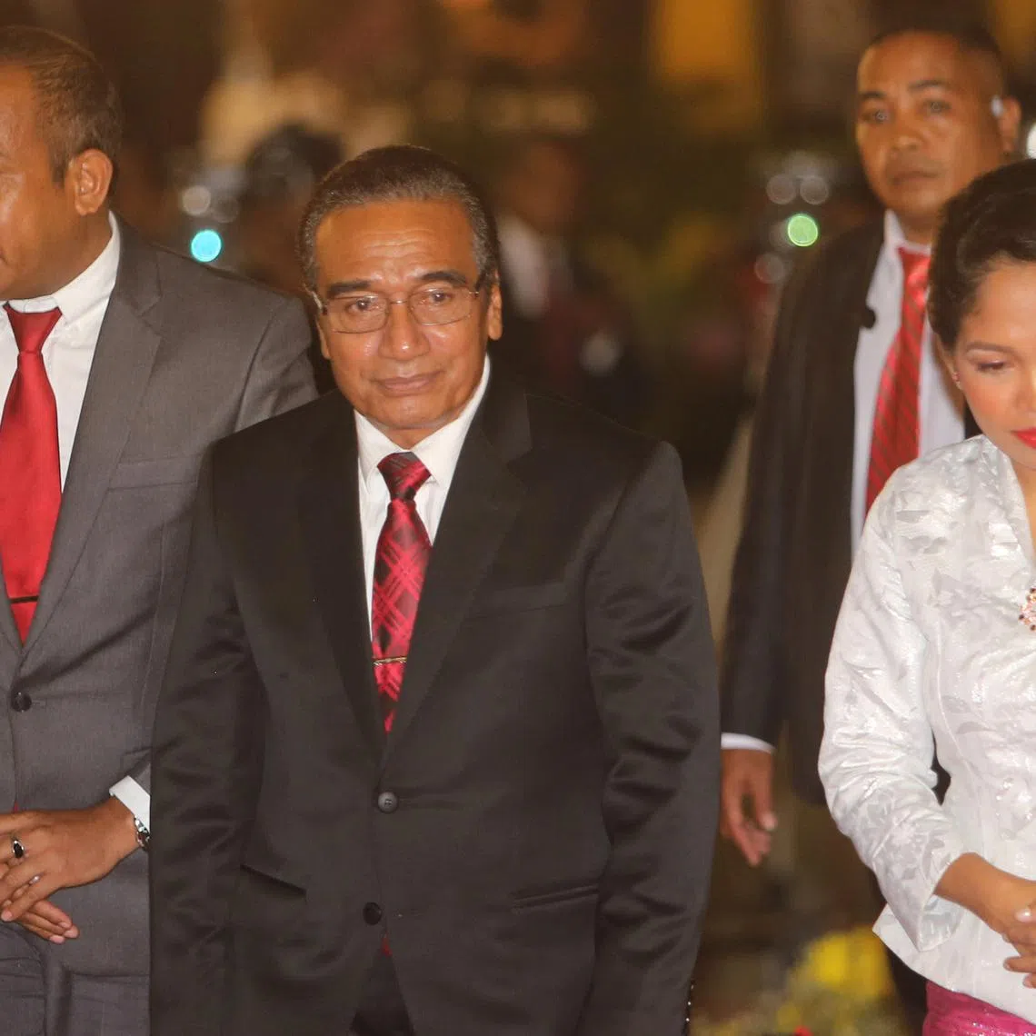 The then-president of East Timor Francisco Guterres Lu'Olo (centre) walks with spouse Cidalia Lopes (right) during presidential inauguration ceremony in Dili on May 19, 2017.
