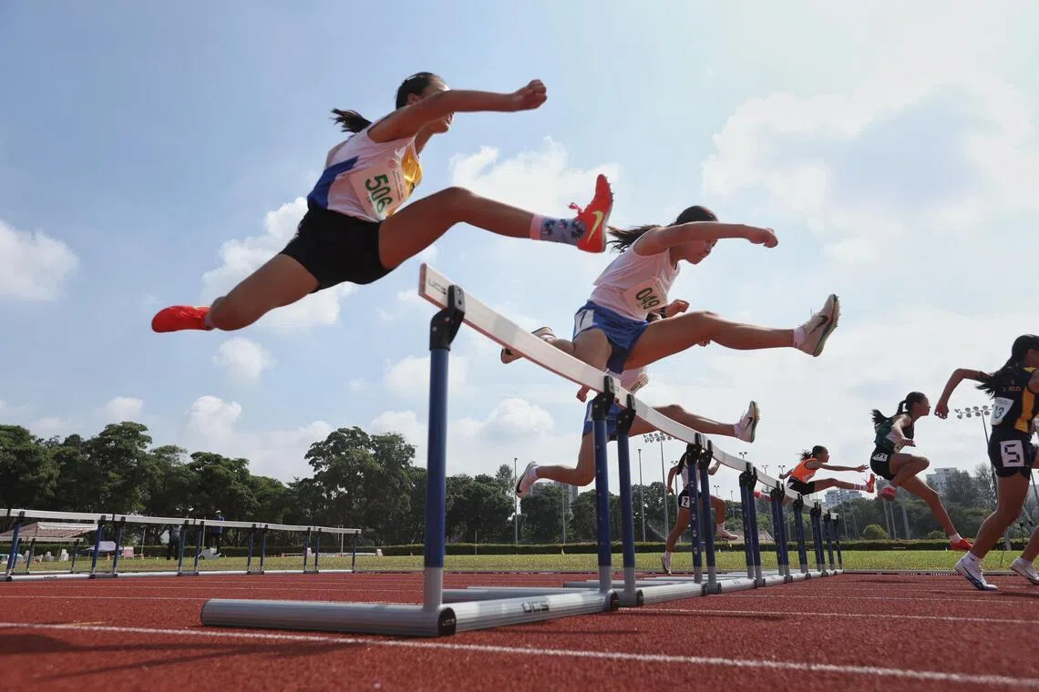 Girls competiting in the National School Games C division 80m hurdles held at the Kallang Practice Track on April 8.