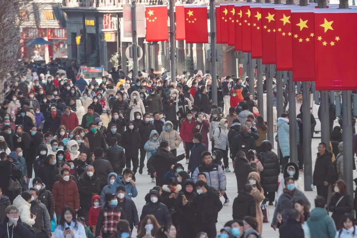 People walk in the main tourist and shopping area of Nanjing street in Shanghai on Jan 27, 2023. 