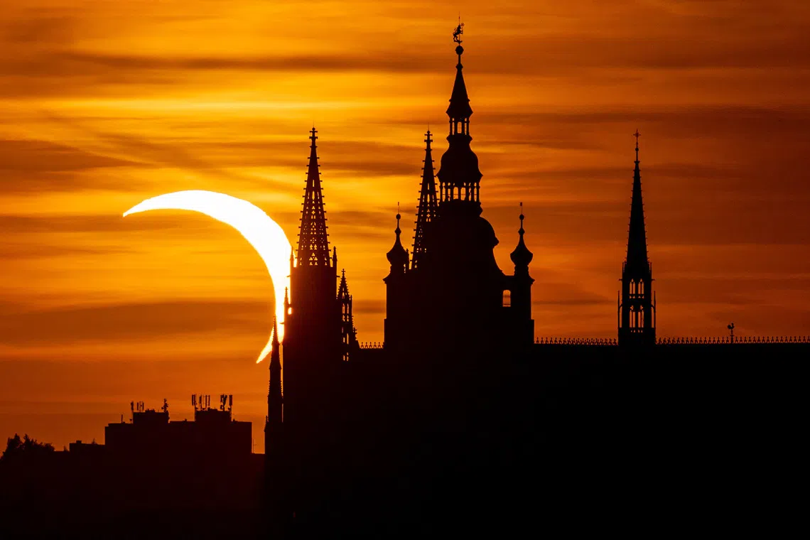 epa13164647 The Prague Castle is silhouetted during a partial solar eclipse in Prague, Czech Republic, 12 August 2026. A total solar eclipse swept across parts of Europe and the North Atlantic on 12 August, with the path of totality moving through Greenland, Iceland, Spain, and a small section of northeastern Portugal, while surrounding areas across Europe experienced a partial solar eclipse, according to the European Space Agency (ESA). EPA/MARTIN DIVISEK