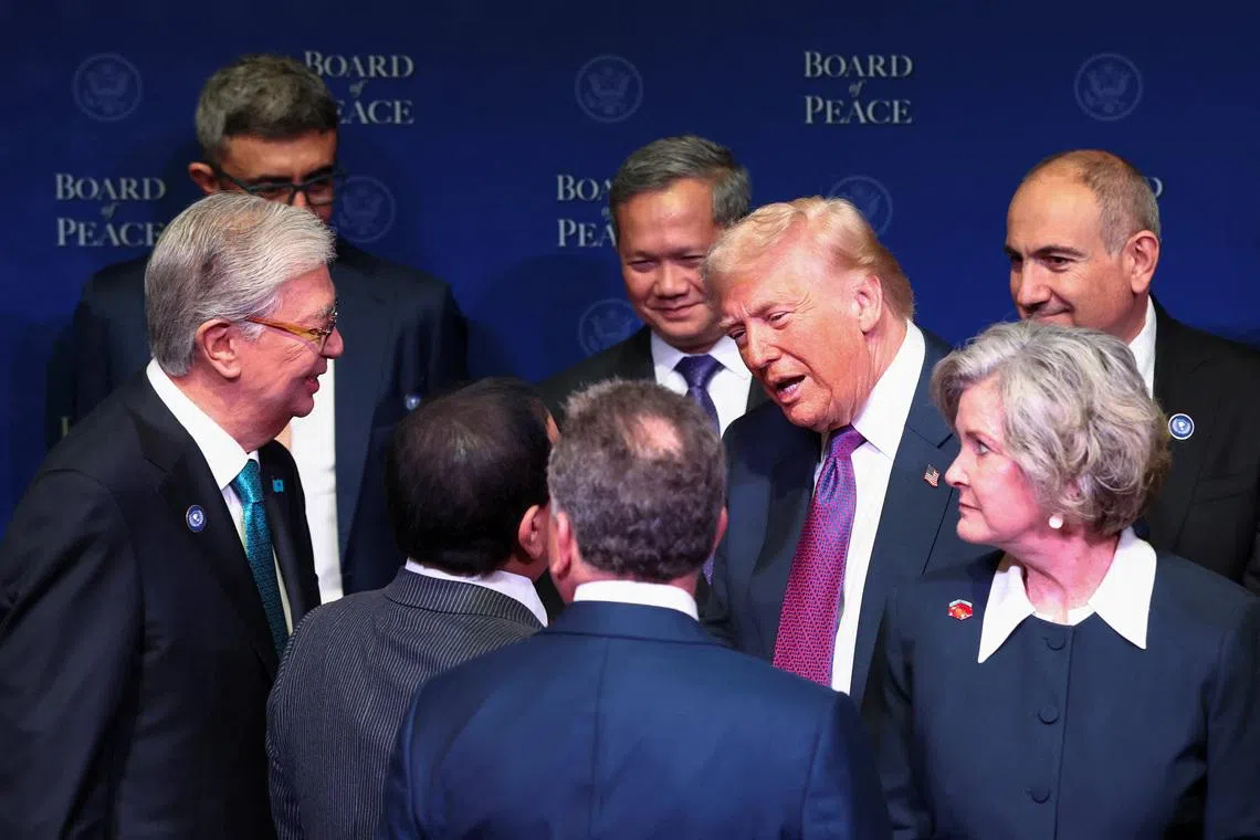 U.S President Donald Trump talks with world leaders participating in the inaugural Board of Peace meeting at the U.S. Institute of Peace in Washington, D.C., U.S., February 19, 2026. REUTERS/Kevin Lamarque