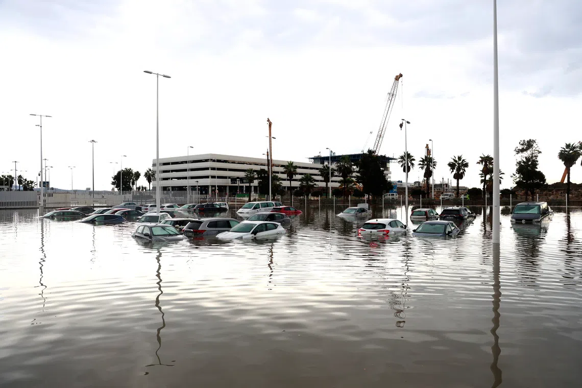 Parked cars are half-submerged in a flooded park area after heavy rainfall that hit the area early in the morning, in the town of Algeciras, southern Spain, on Oct 18.