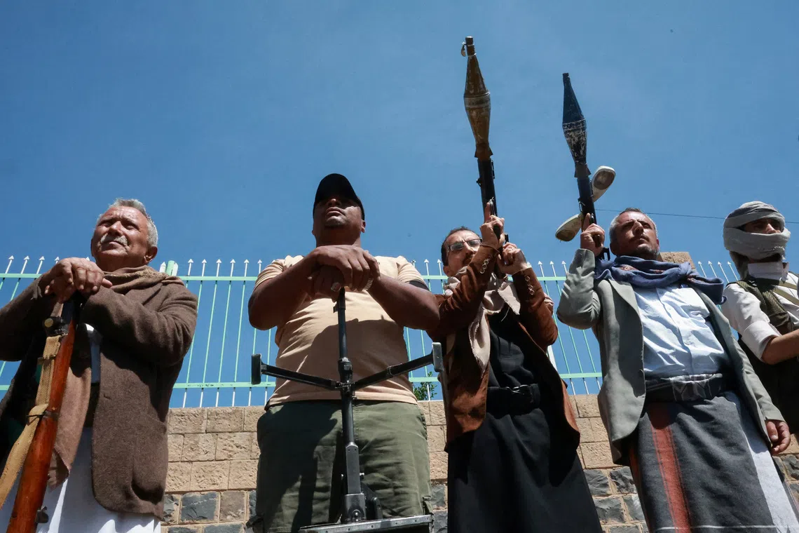 Houthi supporters in Sanaa carry weapons as fighting intensifies across several fronts.