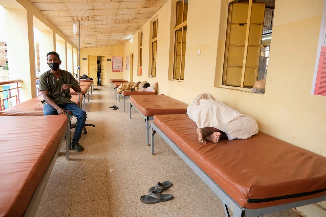 A Sudanese doctor sits on a bed while monitoring dengue fever patients at Omdurman Hospital, as Sudan grapples with outbreaks of dengue and cholera amid the annual rainy season and a collapsed healthcare and infrastructure system, in Khartoum, Sudan, September 23, 2025. REUTERS/El Tayeb Siddig