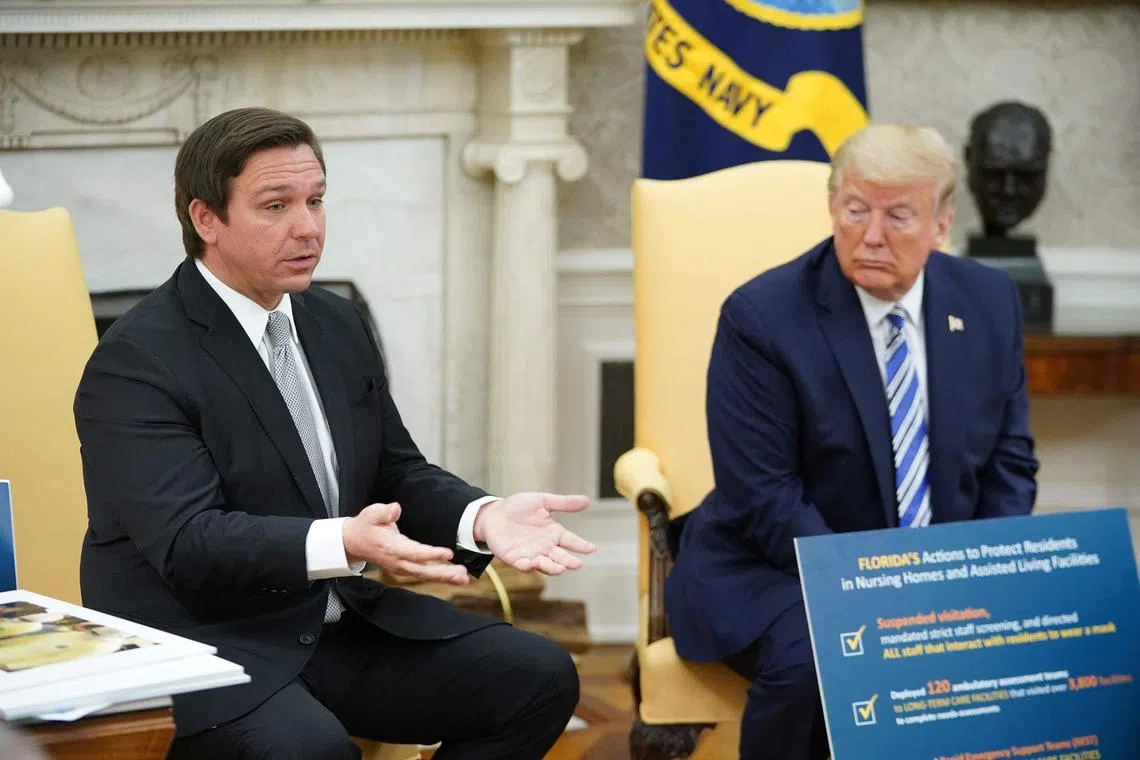 Florida Governor Ron DeSantis (left) is seen with then President Donald Trump in this April 28, 2020 file photo.