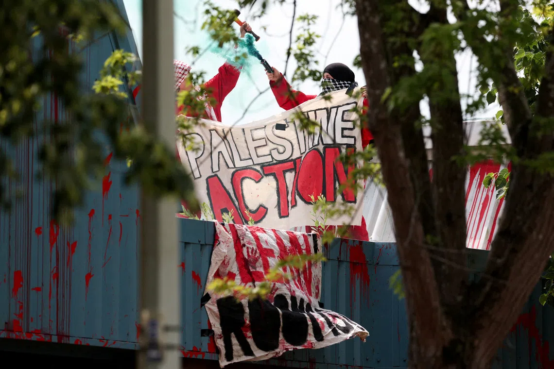 Protesters from \"Palestine Action\" demonstrate on the roof of Guardtech Group in Brandon, Suffolk, Britain, July 1, 2025. REUTERS/Chris Radburn