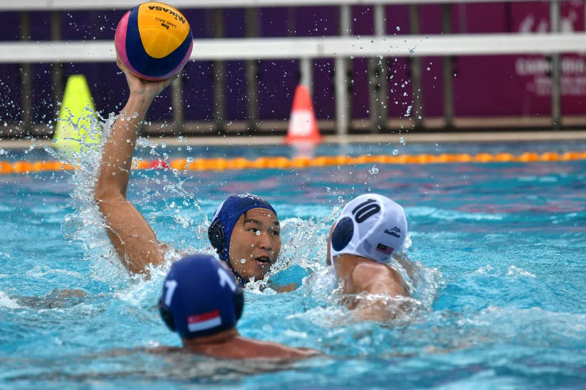 Singapore's water polo team (blue caps) in action against Malaysia at the Cambodia SEA Games. 
