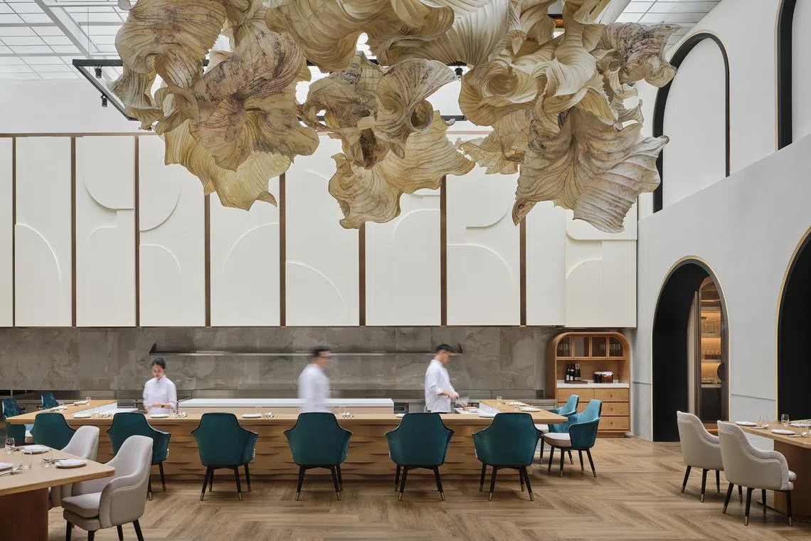 A view of the main dining room at Restaurant Born with its glass ceiling and paper sculpture by Peter Gentenaar. 