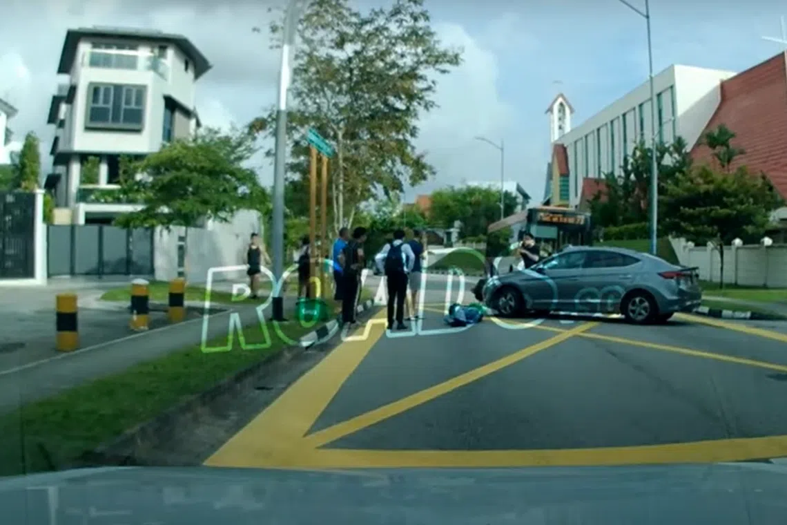 Passers-by were seen trying to check on the motorcyclist following the collision on Monday morning.
