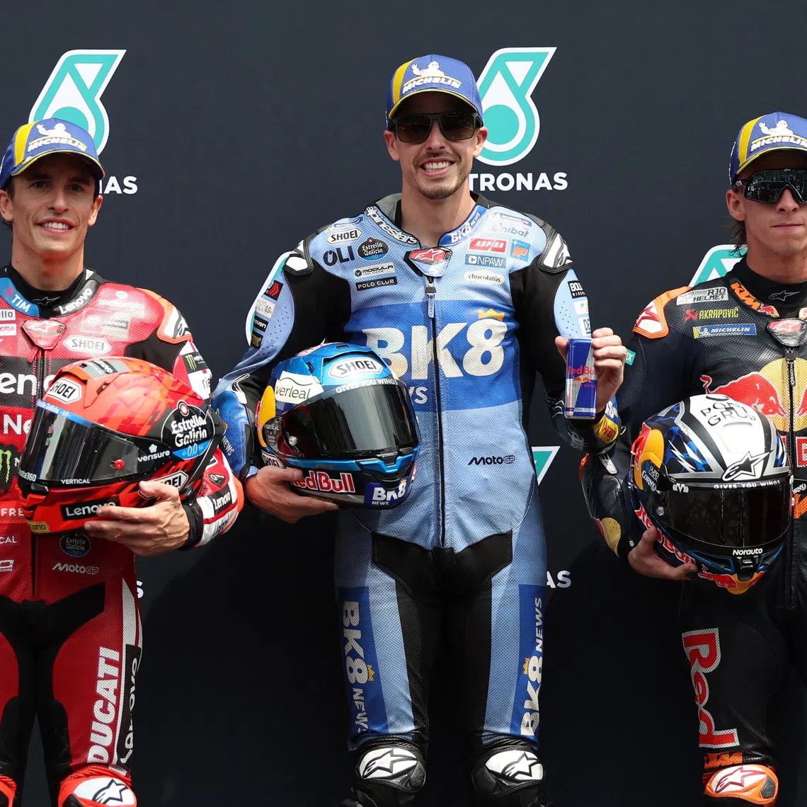 Gresini Racing MotoGP’s Alex Marquez celebrates after qualifying in pole position along with second placed Ducati Lenovo Team’s Marc Marquez and third placed Red Bull KTM Factory Racing’s Pedro Acosta.