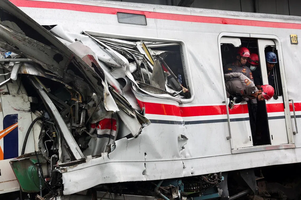 Police officers looking on at the site after a deadly collision between a commuter line train and a long-distance train, in Bekasi, on the outskirts of Jakarta, Indonesia, on April 28, 2026. 