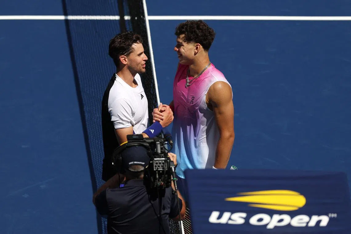 Ben Shelton (right) of the United States shakes hands with Dominic Thiem of Austria after their US Open first-round match in which Thiem lost.