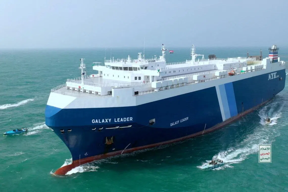 Houthi boats escorting a cargo ship in the Red Sea in November.