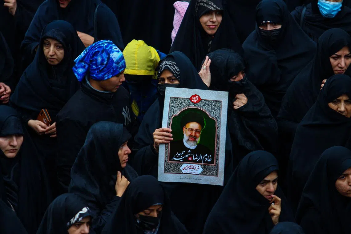 People mourning during the funeral procession of Iranian President Ebrahim Raisi and his seven aides in Tabriz, East Azerbaijan province, Iran, on May 21.