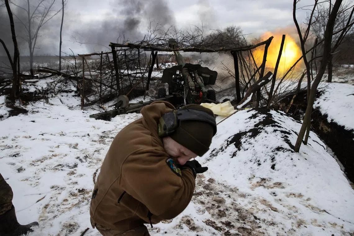 Ukrainian solders fire a howitzer at Russian positions, in the Donbas region of Ukraine.