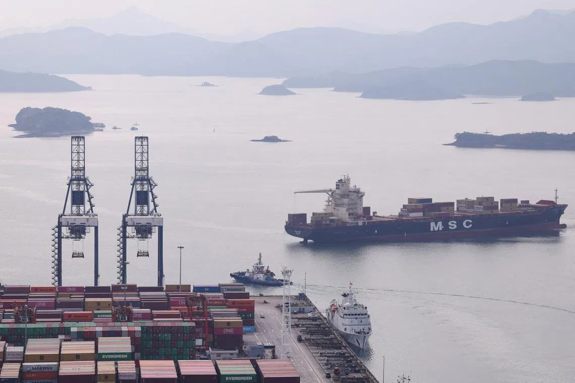 FILE PHOTO: A cargo ship carrying containers approaches a terminal of the Yantian port in Shenzhen, Guangdong province, China October 30, 2025. REUTERS/Tingshu Wang/File Photo