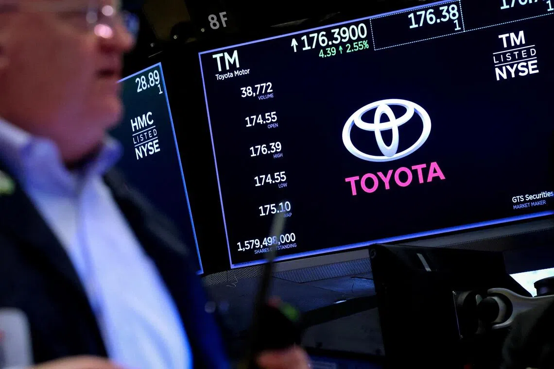 FILE PHOTO: Screens display the trading information and company logo for Toyota as a trader works on the floor at the New York Stock Exchange (NYSE) in New York City, U.S., April 15, 2025.  REUTERS/Brendan McDermid/File Photo