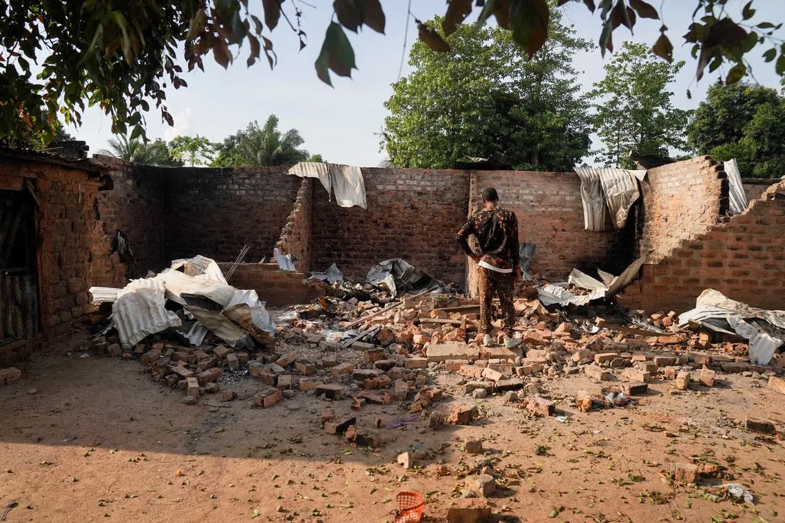 FILE PHOTO: A man stands in front of a damaged and burnt house following a deadly gunmen attack in Yelwata, Benue State, Nigeria, June 16, 2025. REUTERS/Marvellous Durowaiye/File Photo