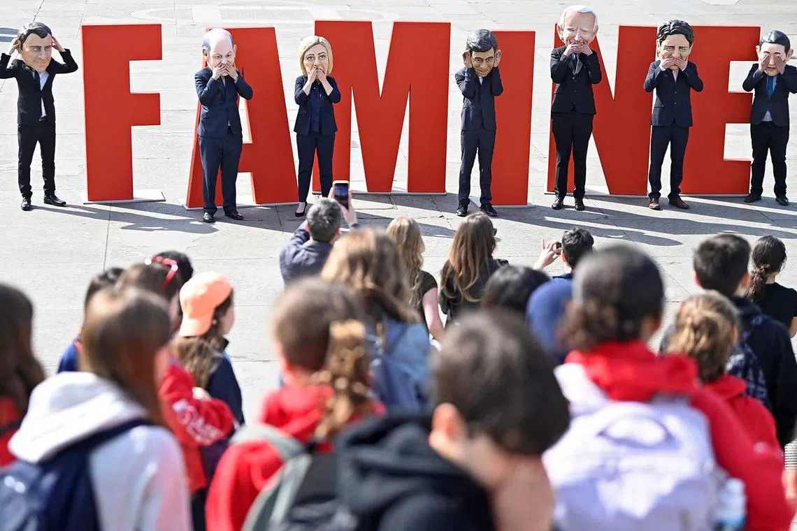 Campaigners from Oxfam, wearing costumes depicting major world leaders, protest over a hunger crisis in East Africa, ahead of the G7 leaders' summit in Japan, at Trafalgar Square in London, Britain, May 17.