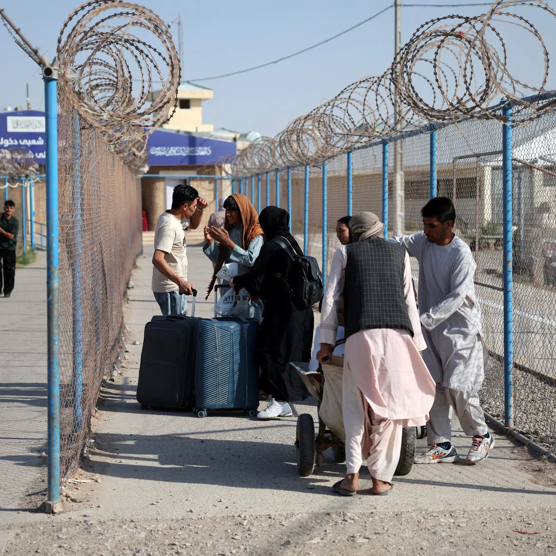 Afghan nationals carrying their belongings walk after crossing the border from Iran at the Islam Qala border crossing in Herat province, Afghanistan, September 3, 2026. REUTERS/Sayed Hassib