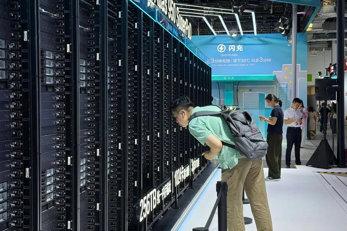 A visitor leans in for a closer look at Huawei’s Atlas 950 SuperPod at the World AI Conference in Shanghai.