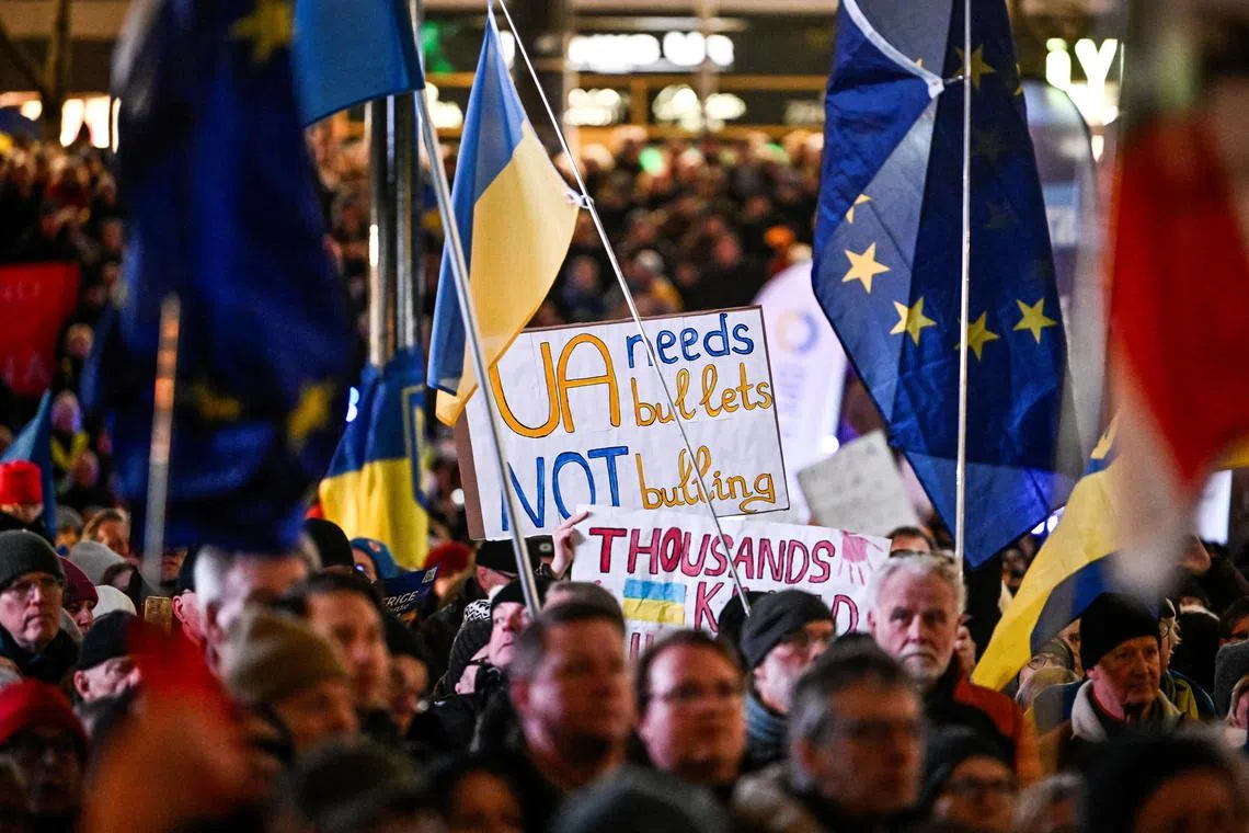 People taking part in a pro-Ukraine rally in Sweden, on the third anniversary of Russia's invasion.