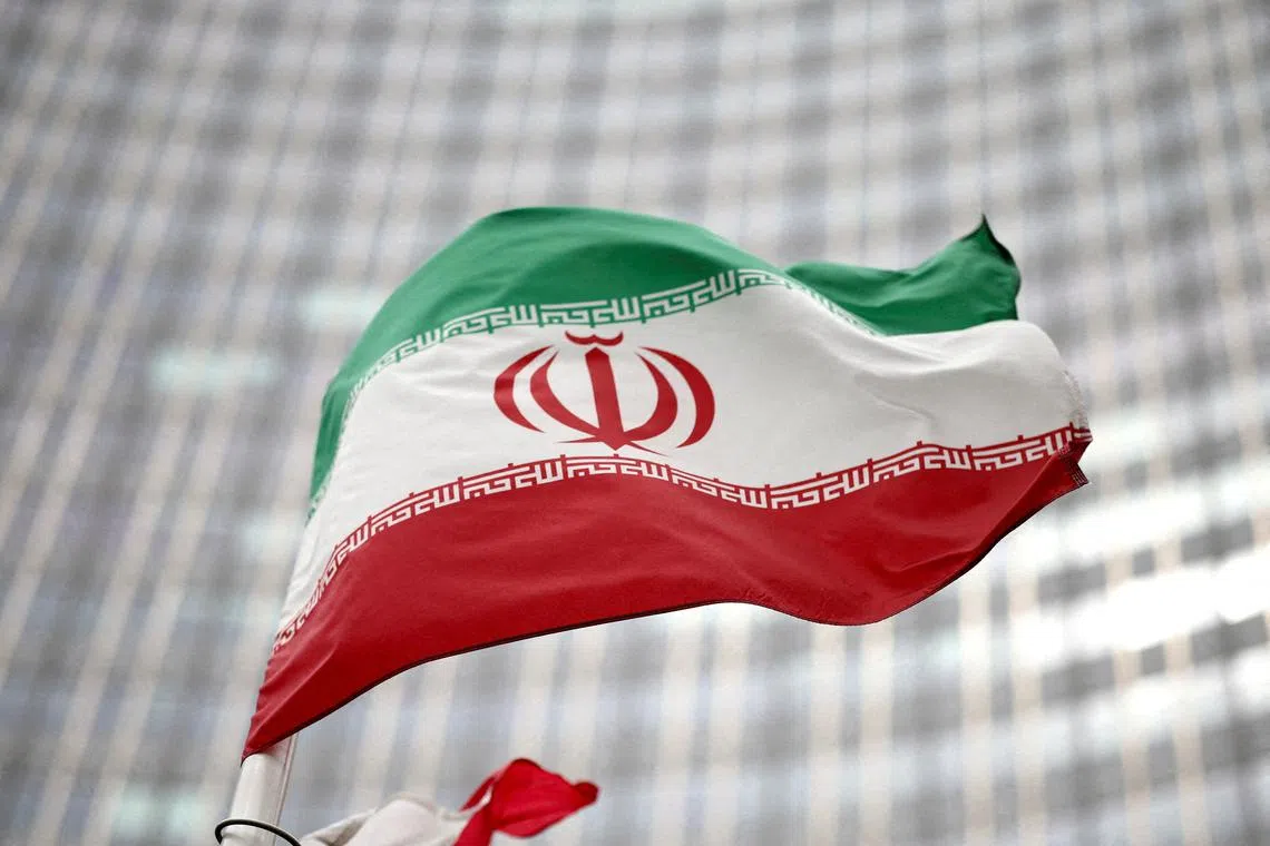 FILE PHOTO: Iranian flag flies in front of the UN office building, housing IAEA headquarters in Vienna, Austria, May 24, 2021. REUTERS/Lisi Niesner/File Photo