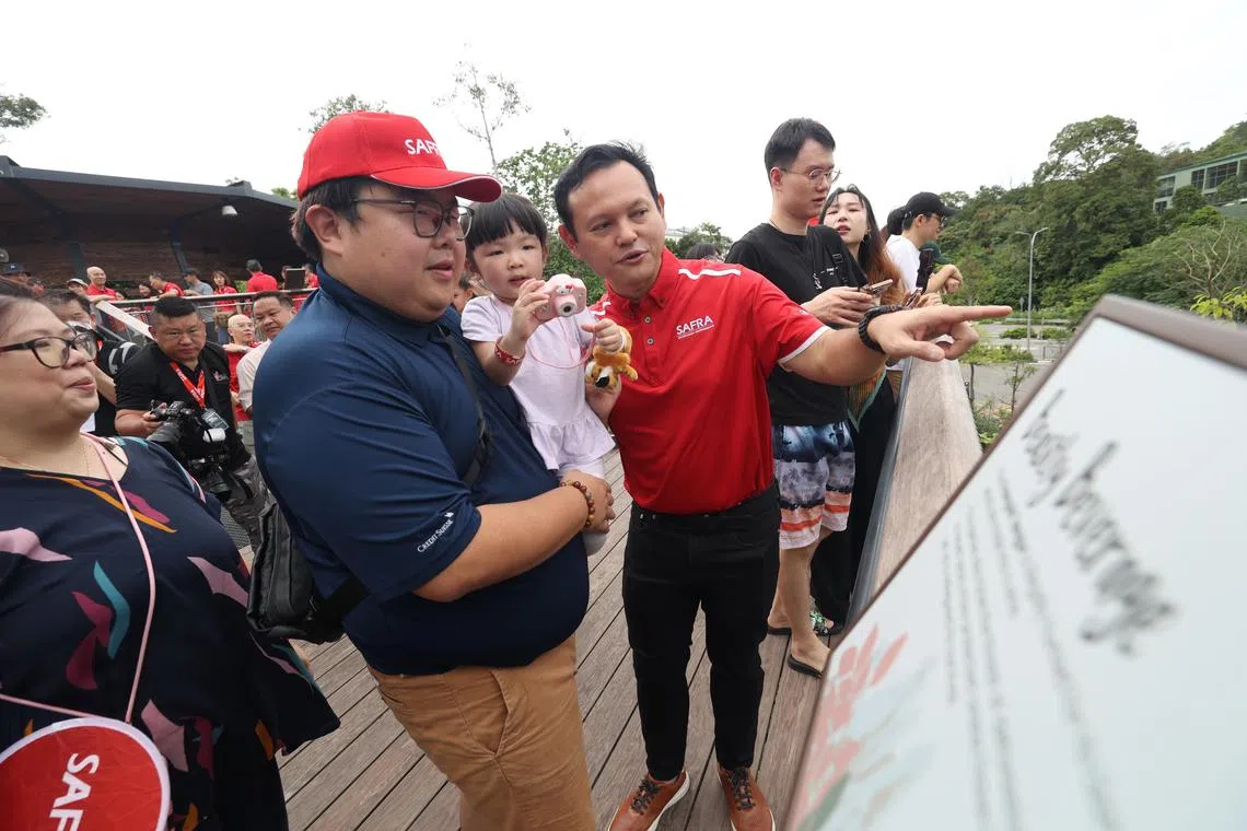 Senior Minister of State for Defence and Safra president Zaqy Mohamad (in red) with Mr Avier Ling and his daughter Annette at the Safra Family Day Out on March 16.