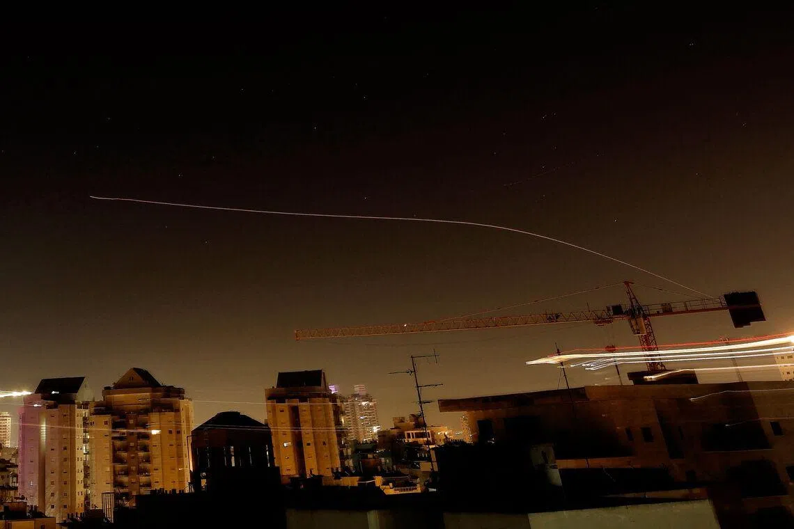 Rocket trails in the sky above the Israeli coastal city of Netanya amid a fresh barrage of Iranian missile attacks on March 17.