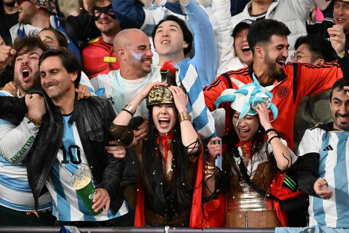 Argentina fans celebrate after their team won its cup final match against France on the third day of the 2025 Rugby Sevens Hong Kong tournament at the Kai Tak sports stadium on March 30, 2025. (Photo by Peter PARKS / AFP)