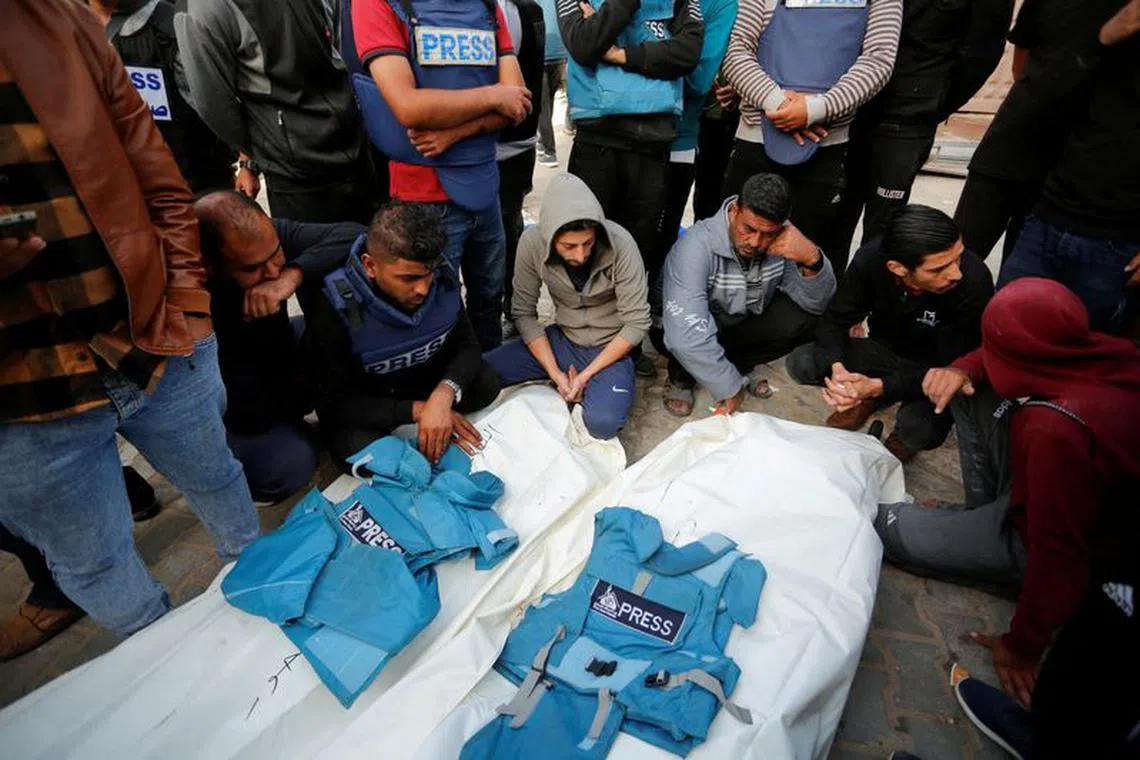 Palestinians mourn local journalists Hassouna Sleem and Sary Mansour, who were killed in an Israeli strike on a house, at a hospital in the central Gaza Strip November 19, 2023. REUTERS/Stringer