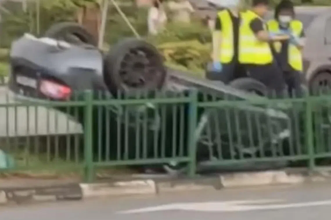 Videos circulating on social media show an overturned grey sports car on a road divider along Upper Thomson Road.