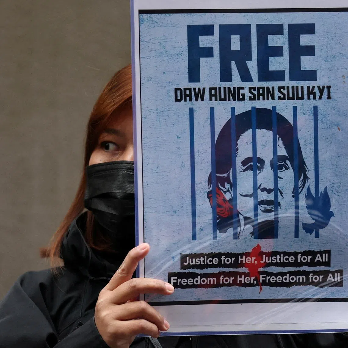 FILE PHOTO: A Myanmar protester living in Japan holds a placard of Myanmar's detained former leader, Aung San Suu Kyi, during a rally denouncing an upcoming election led by the military junta, outside Myanmar's embassy in Tokyo, Japan, December 14, 2025. REUTERS/Issei Kato/File Photo