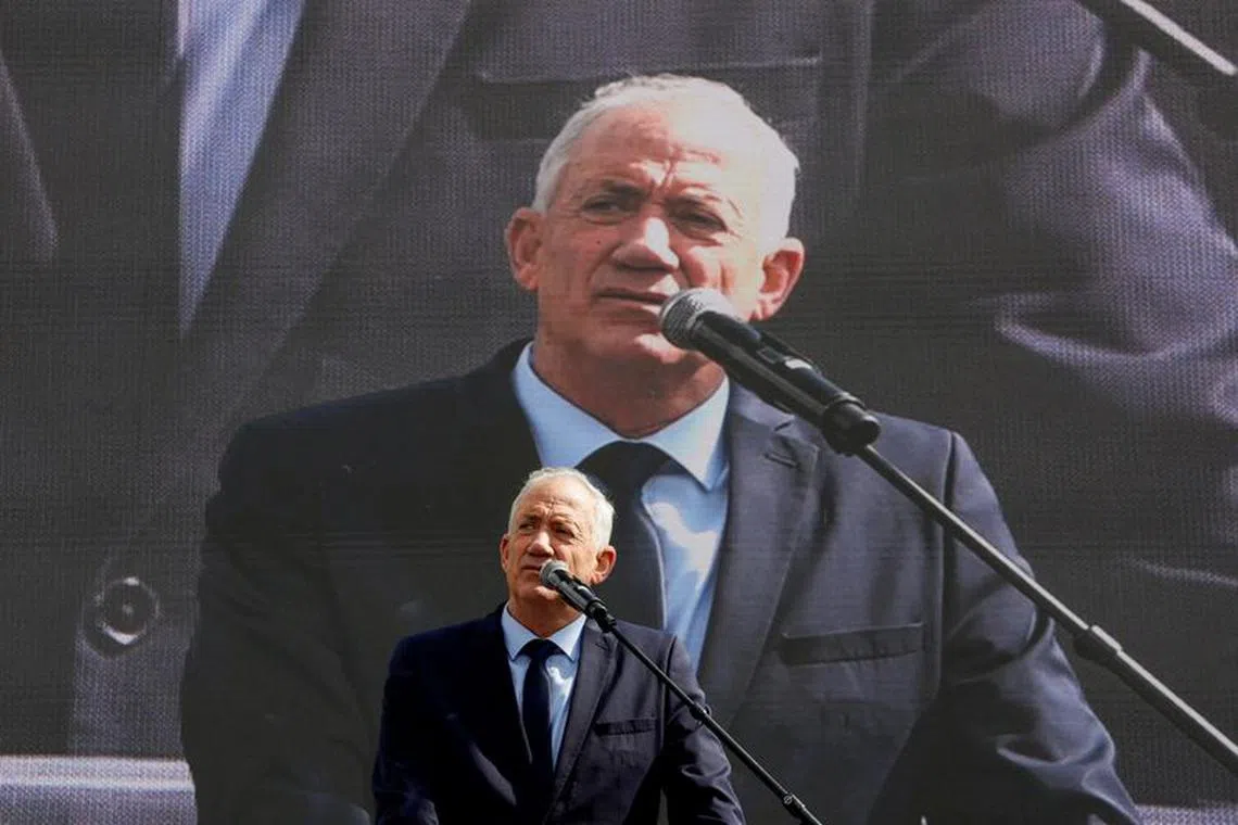 Israel's opposition leader Benny Gantz addresses protesters at a demonstration after Israeli Prime Minister Benjamin Netanyahu dismissed the defense minister as his nationalist coalition government presses on with its judicial overhaul, in Jerusalem, March 27, 2023. REUTERS/Ammar Awad/File Photo
